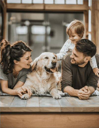 Adorable family enjoying quality time with their beloved dog indoors.