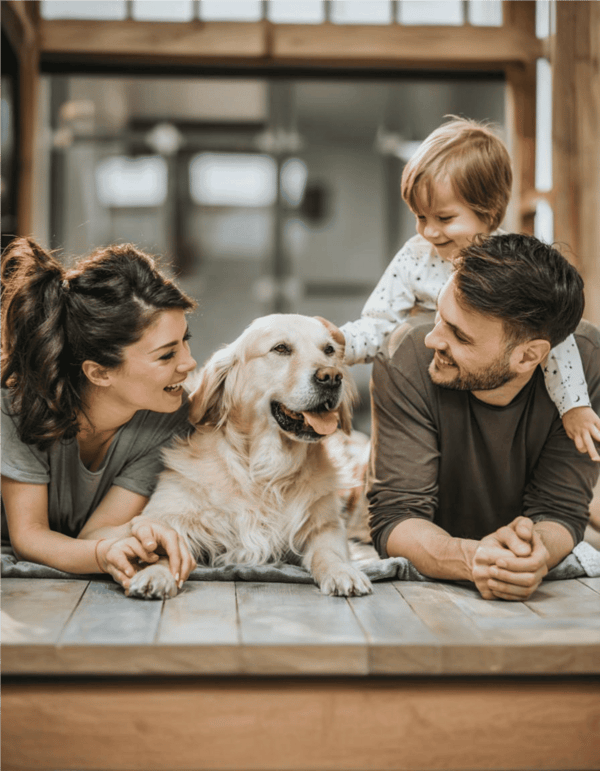 Adorable family enjoying quality time with their beloved dog indoors.