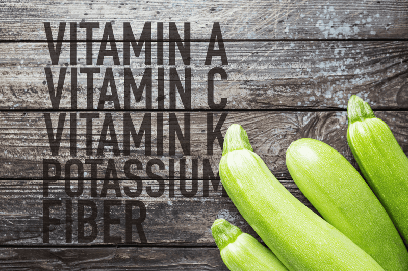 Colors: Green, Fresh Vegetables, Zucchini on Rustic Wooden Background.