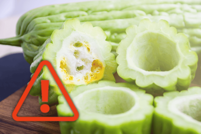 Fresh sliced bitter melon vegetable, healthy food concept, caution sign for potential health risks.