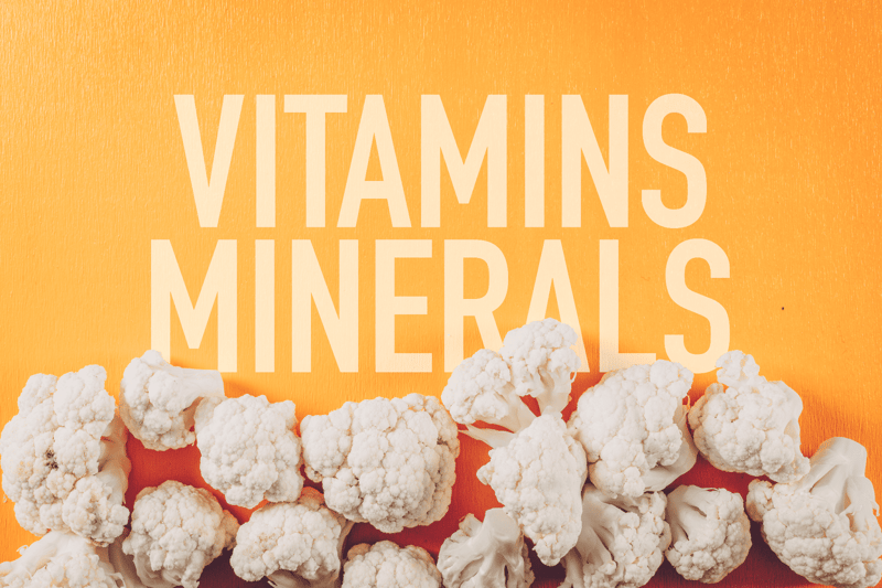 Alt text: Cauliflower florets on a yellow background with bold text about dog vitamins and minerals.