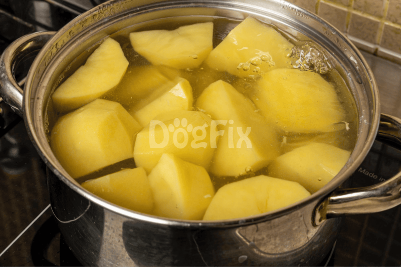 Image of chopped potatoes boiling in a pot, prepared as a healthy dog food ingredient.