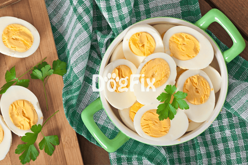 Alt text: Sliced boiled eggs in a green bowl with parsley, on a checkered cloth.