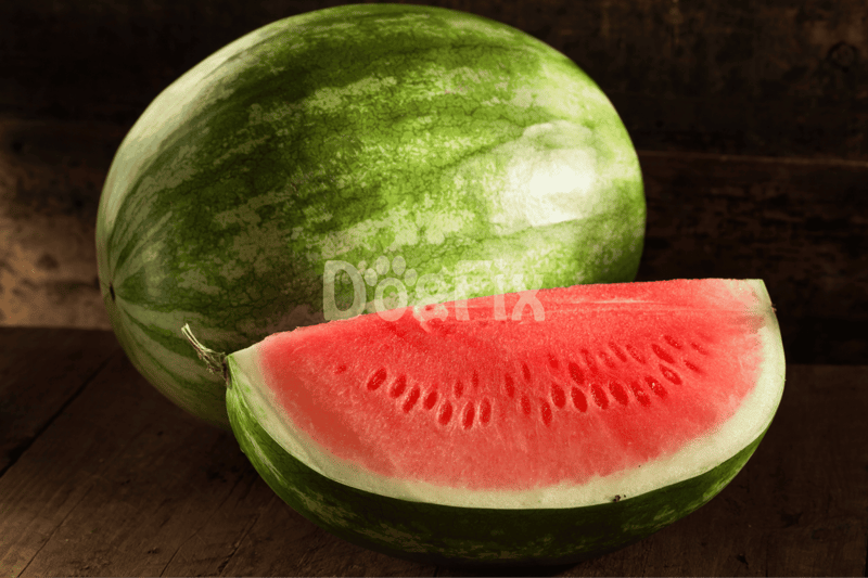 Close-up of a sliced juicy watermelon on rustic wooden surface.