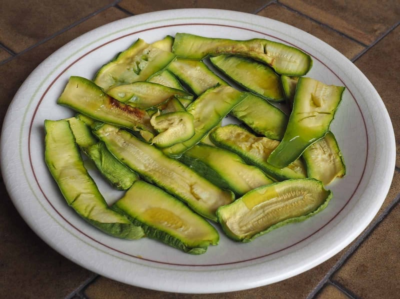 Healthy roasted green bell peppers served on a white plate.