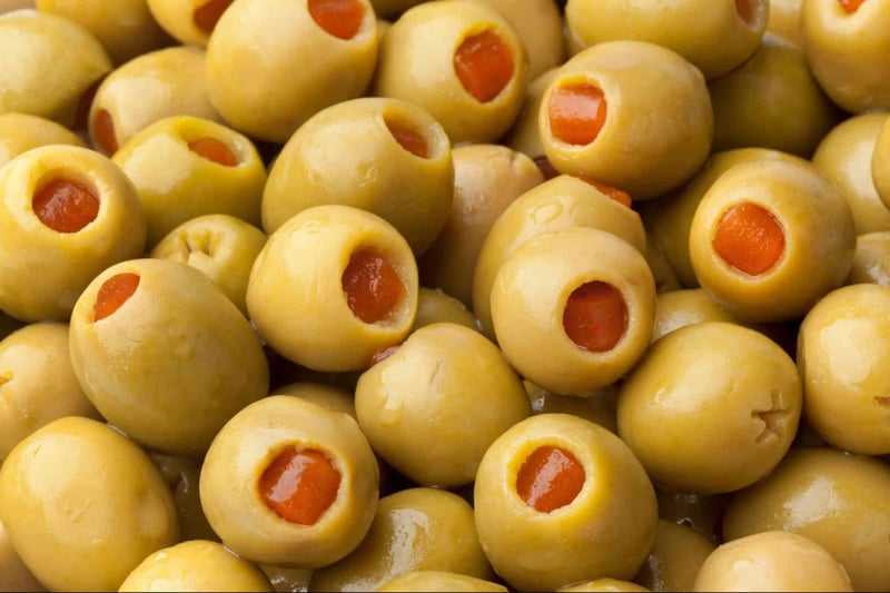 Delicious stuffed green olives filled with bright red pimentos, perfect for appetizers or snacks.
