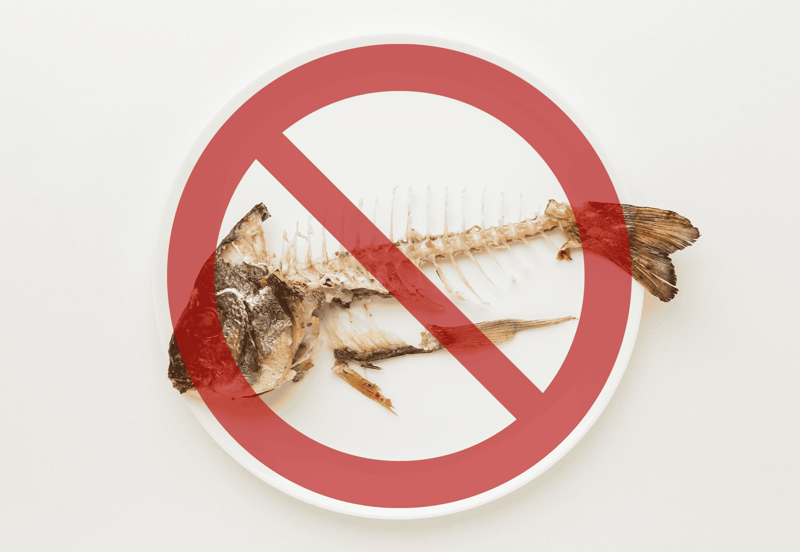 Fish bones on a plate with 'no' symbol overlay.