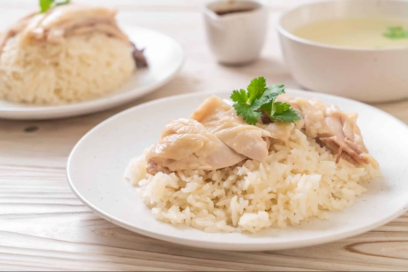 Delicious chicken rice served with cilantro, perfect for Chinese cuisine enthusiasts.