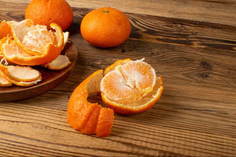 Orange citrus fruit with peel and segments, healthy snack option.