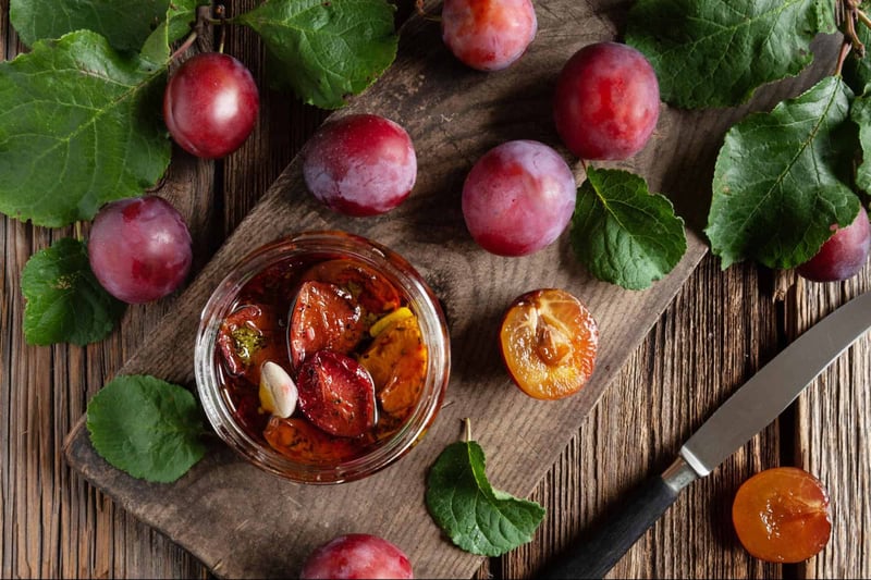 Fresh grapes and cherry tomatoes on rustic wooden table for healthy snack ideas.