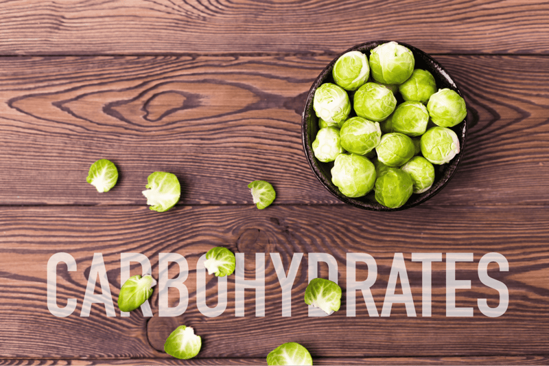 Fresh Brussels sprouts in a black bowl, perfect for healthy dog treats or meals.