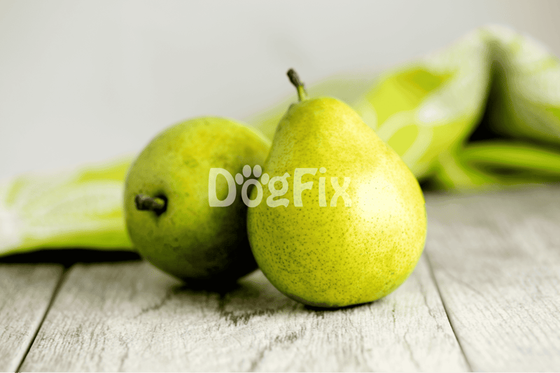 Fresh green pears on rustic wood with blurred background emphasizing healthy dog treats.