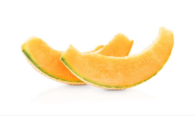 Vibrant orange cantaloupe slices with green rind, showcasing a juicy, sweet interior.