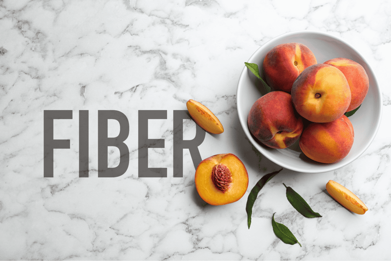 Peach and slice on marble surface, promoting fiber-rich diet, healthy snacks for dogs, natural nutrition.