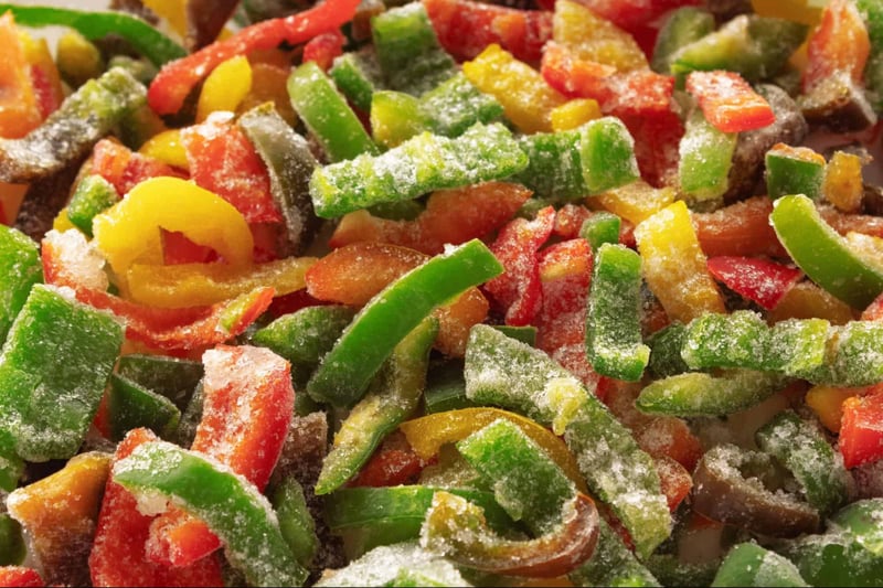 Fresh frozen dog vegetables with vibrant red, green, yellow, and orange colors, perfect for pet meals.