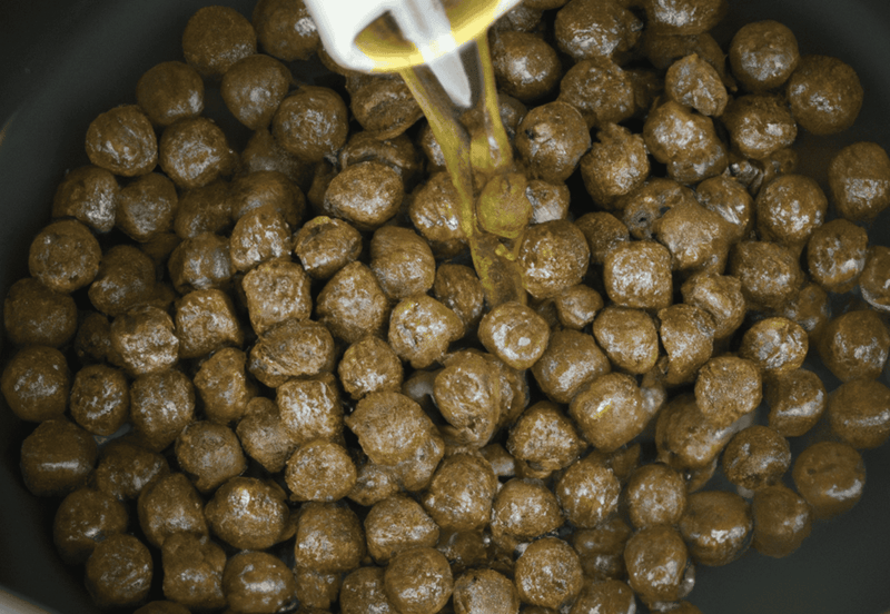 High-quality dry dog food being prepared in a pan.