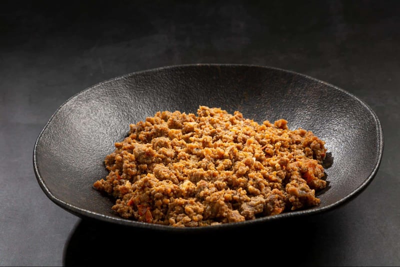Healthy homemade dog food served in a black dish, fresh and nutritious meal option.