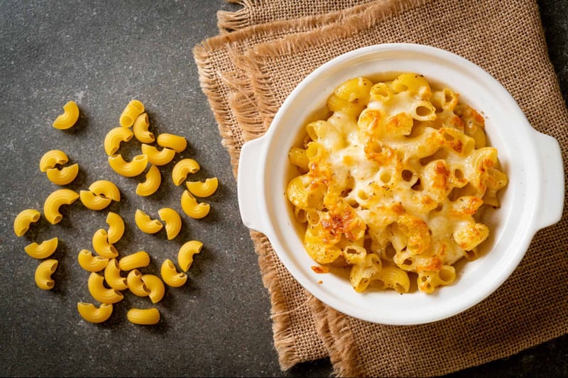 Delicious baked macaroni and cheese with melted cheese in a white bowl, cozy food presentation.