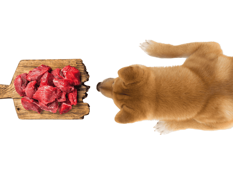 Image of raw, tender beef chunks on a rustic wooden board.