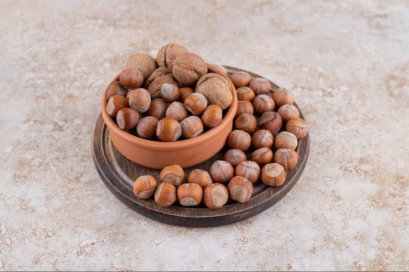 Hazelnuts and walnuts in a bowl for dog-safe treats.