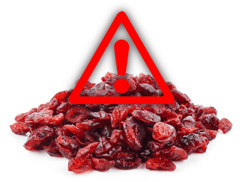 Warning sign overlay on dried berries poses health risk to dogs.