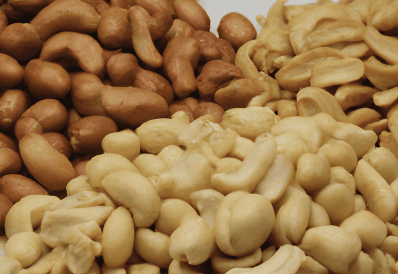 Close-up of mixed dog-safe nuts and seeds, including cashews, peanuts, and sunflower seeds.
