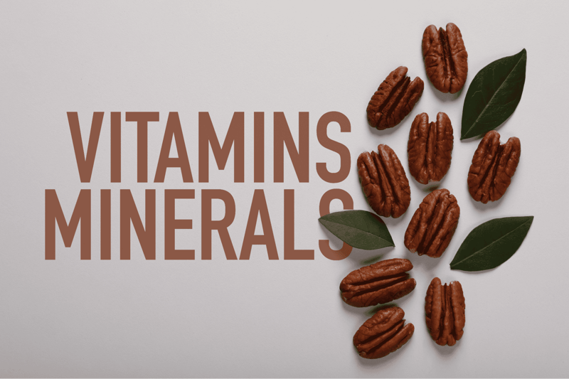 Close-up of pecans and green leaves on a white background, emphasizing canine nutrition benefits.