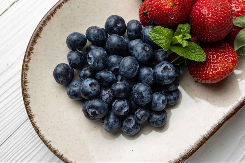 Fresh blueberries and strawberries for healthy dog treats.