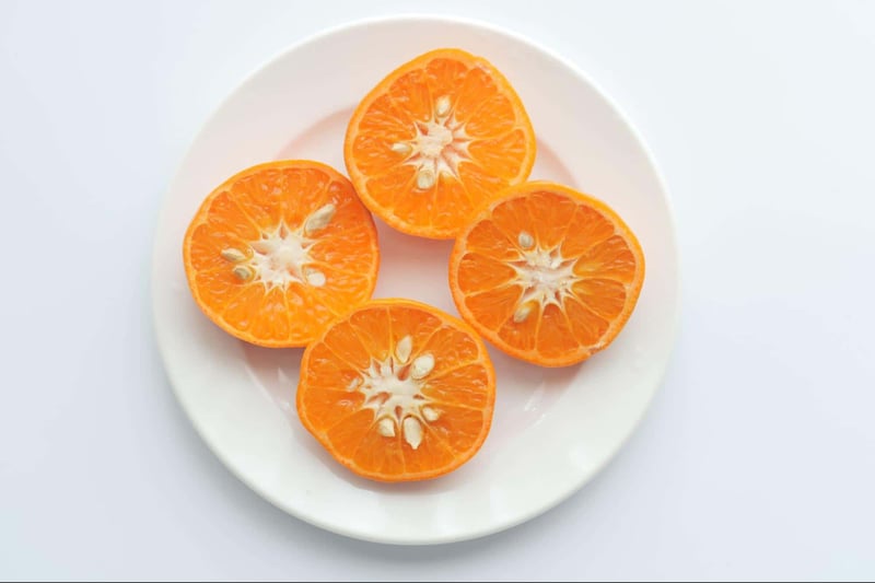 Fresh citrus fruit slices with bright orange color and juicy pulp.