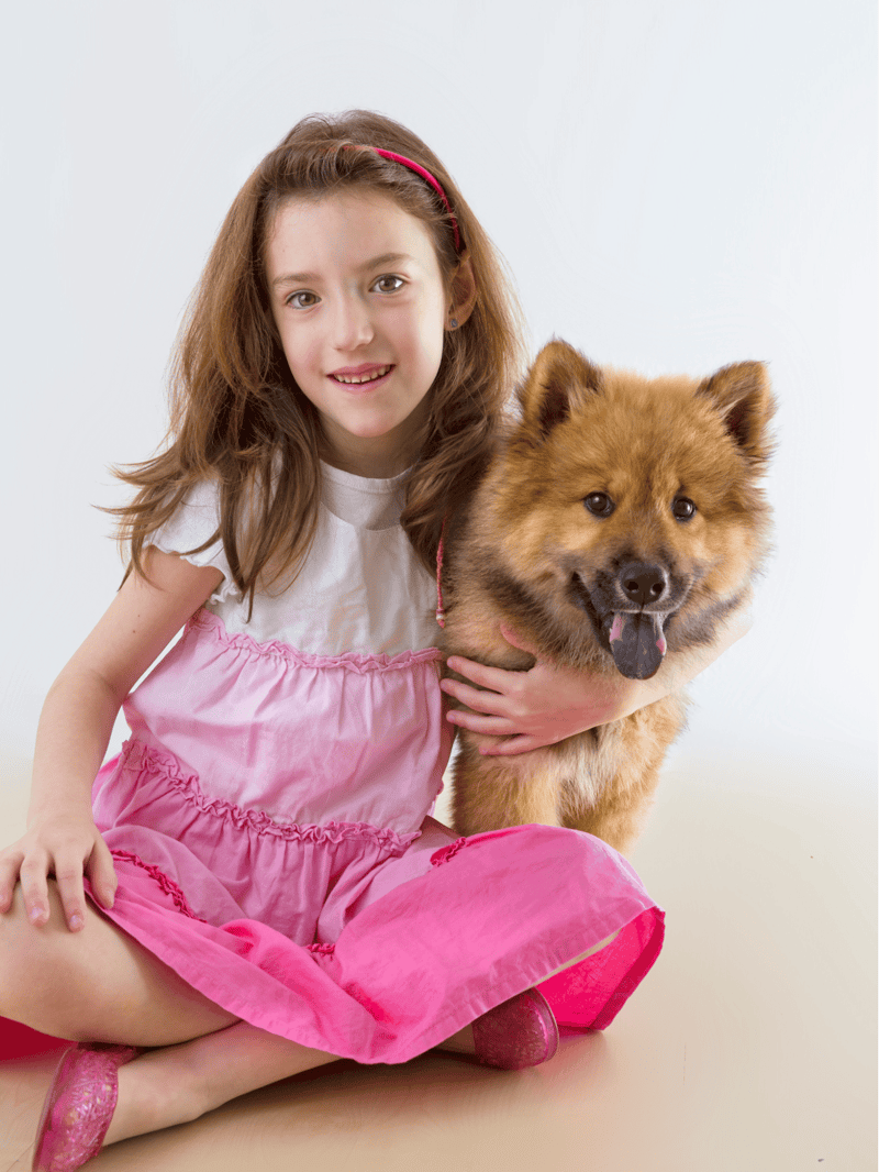 Girl and adorable fluffy dog, enjoying pet companionship, happy moments.