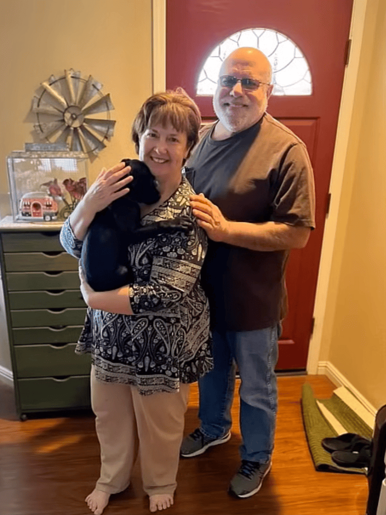 Adorable moment with dog and owners in cozy home setting.