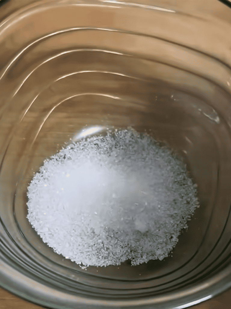 Close-up of salt in glass bowl for pet or household use.
