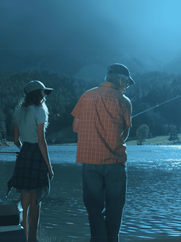 Family fishing by the tranquil lake at sunset, enjoying quality outdoor time.