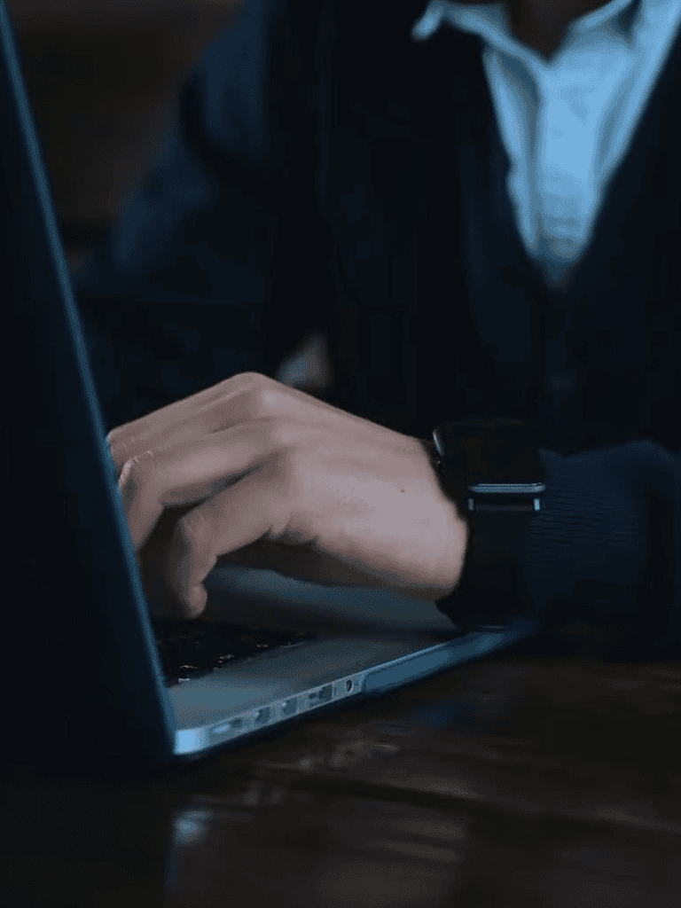 Person working on laptop for dog-related services.