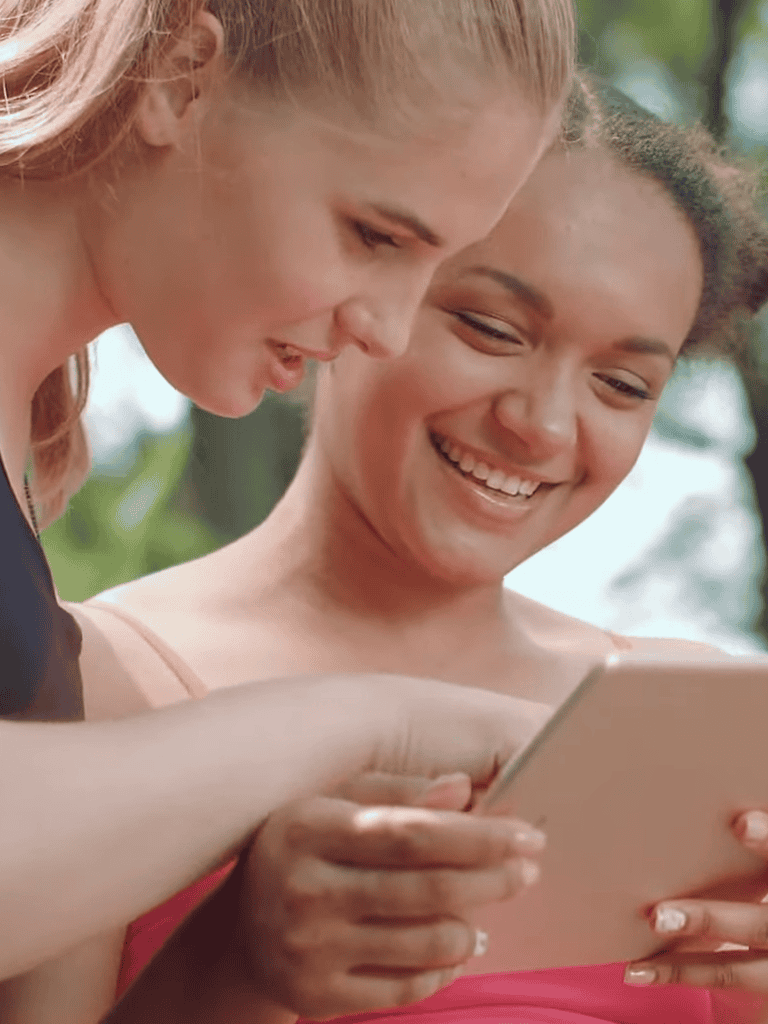 Happy women using DogFix app on phone.