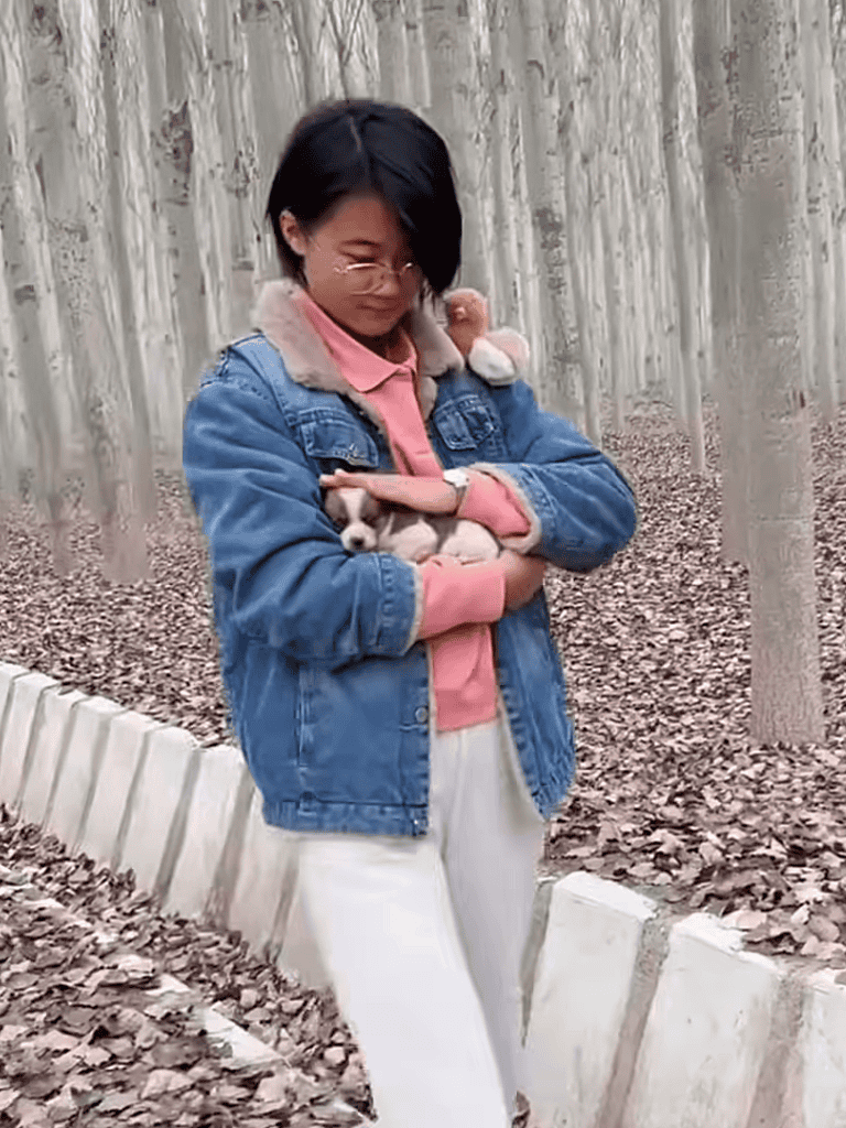 Adorable girl holding a tiny puppy in her arms, showcasing love and care for dogs in a natural outdoor environment.