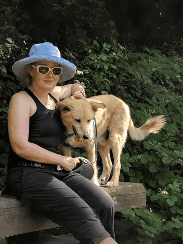 Dog-friendly outdoor park scene with woman and golden retriever.