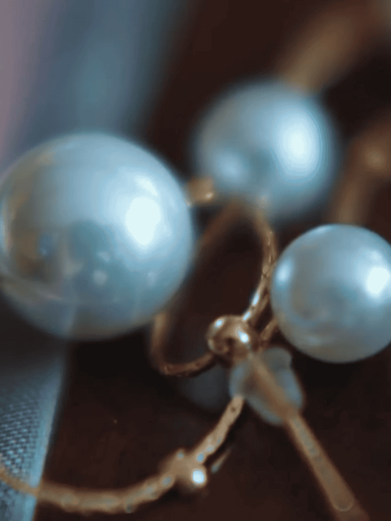 Elegant pearl earrings featuring silky white pearls with gold accents.