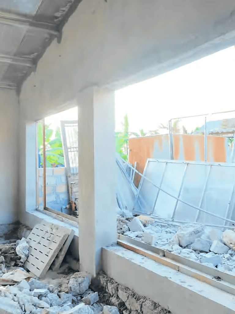Construction site for new building with unfinished walls and construction debris.