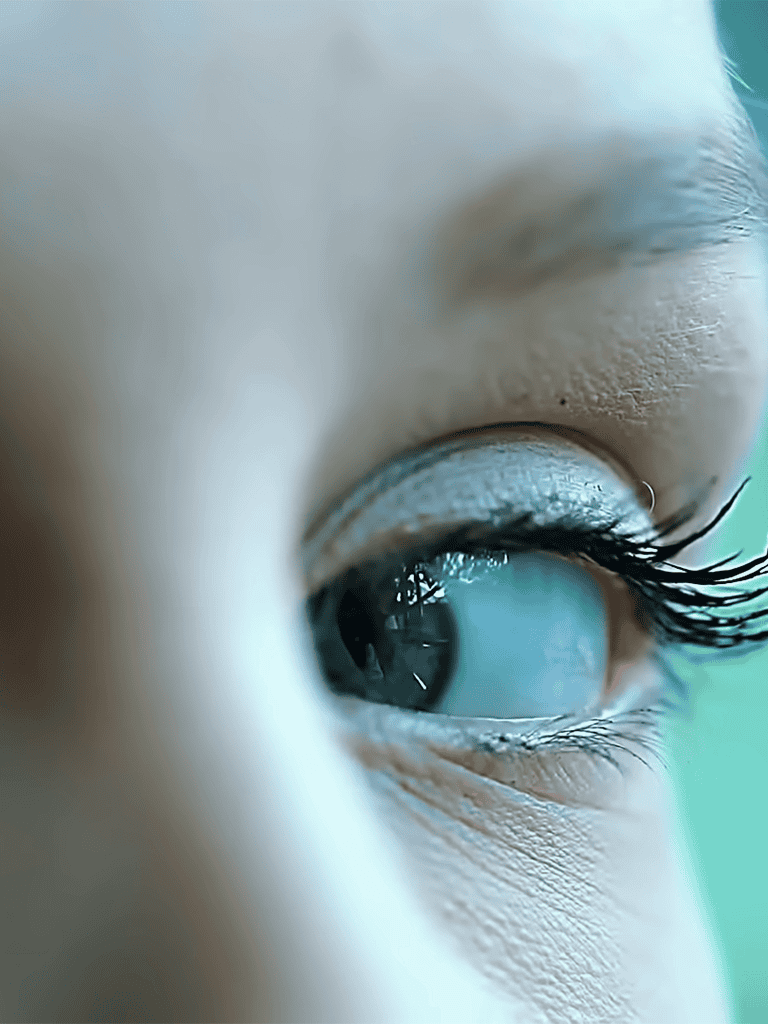 Close-up of a child's blue eye showing eyelashes and detailed eyelid.