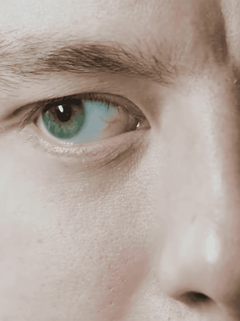 Close-up of a human eye with vivid blue color and detailed skin texture.