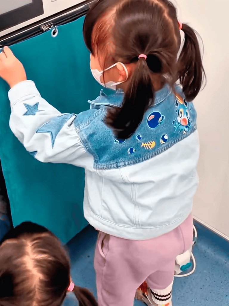 Child receiving gentle dog grooming at a pet salon in caring environment.