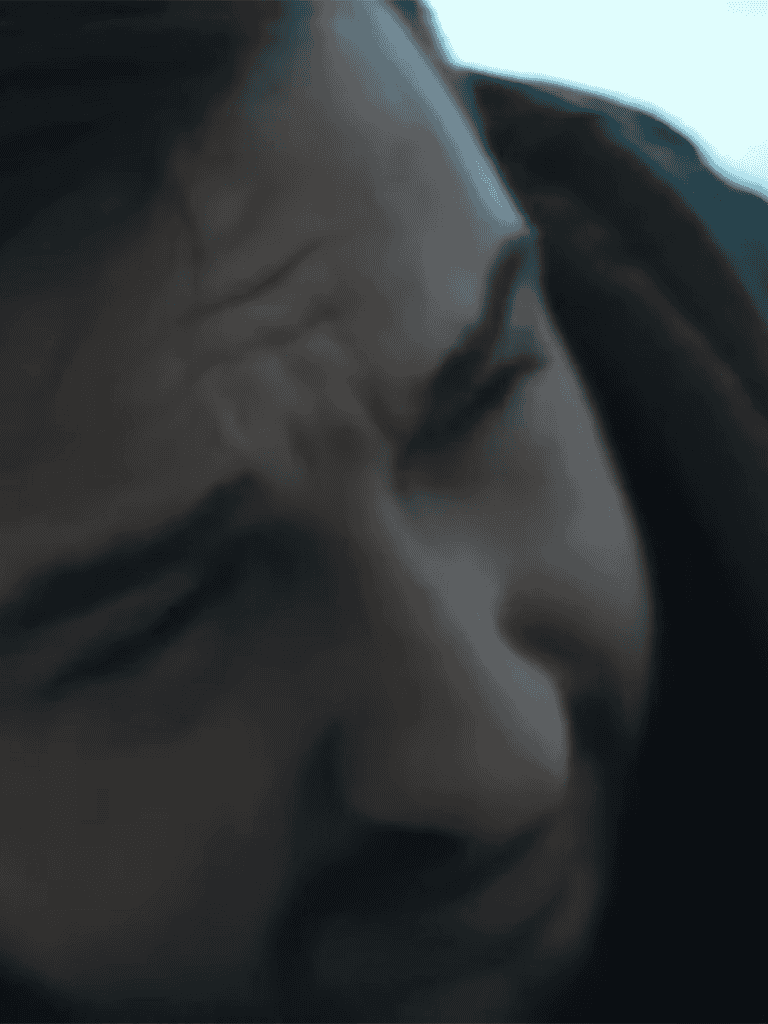 Close-up of a stressed woman holding her head in frustration.