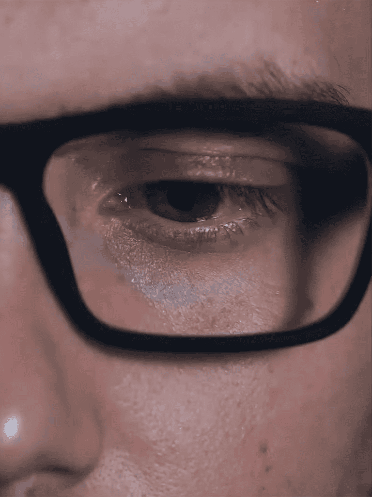Close-up of a person's eye and glasses, emphasizing attention to eye health and vision care.