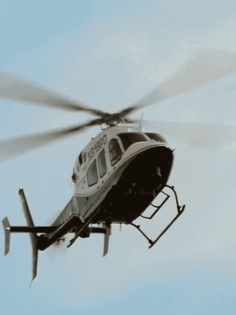 Rescue helicopter flying in sky for emergency dog rescue missions.